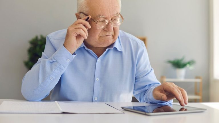 bxblue - homem de terceira idade pesquisando online, fazendo anotações, pensativo - quais bancos oferecem credito consignado para aposentados inss