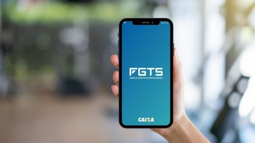 adesão ao saque-aniversário - mãos segurando celular com o aplicativo do FGTS